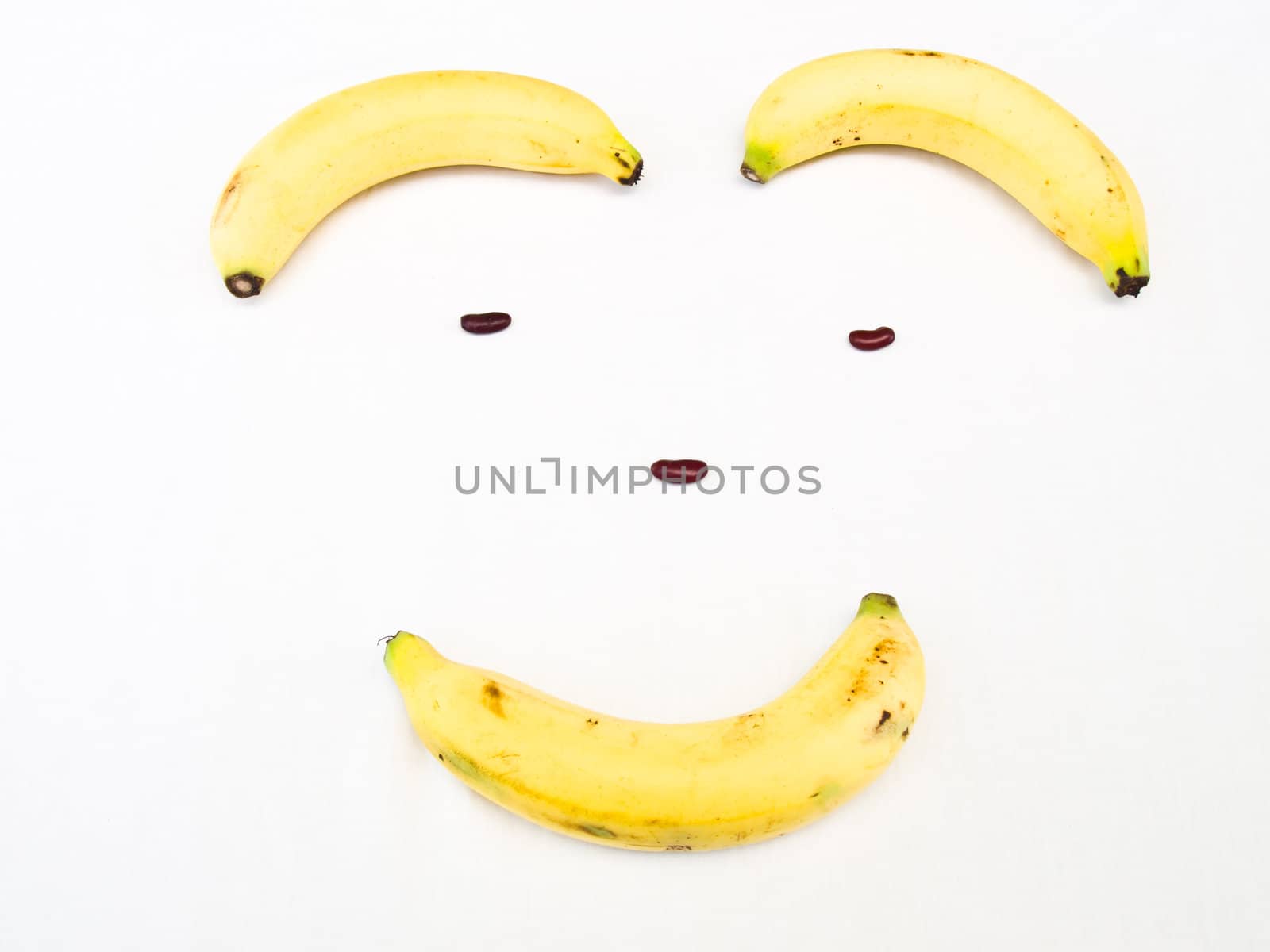 Smiling face made from banana and kidney bean Banana isolated on by gururugu