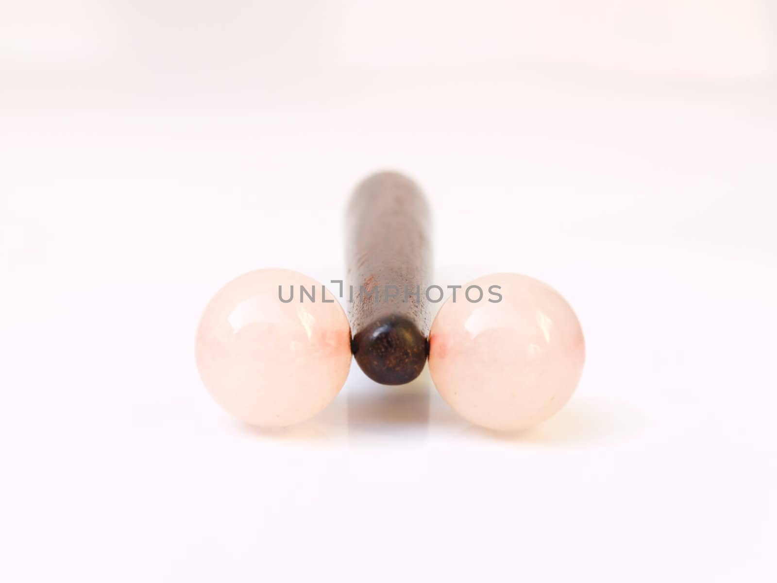 Wooden facial massage stick isolated on white background by gururugu
