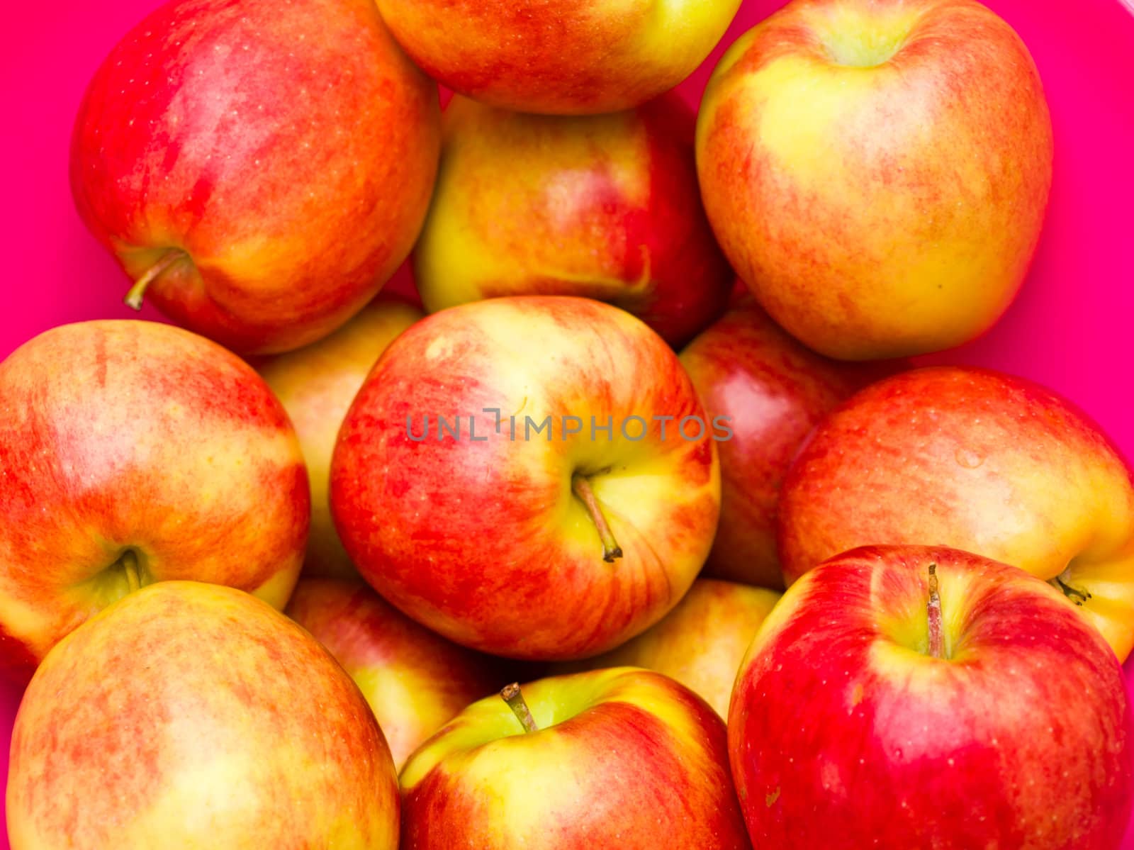 Red apples isolated on pink background by gururugu