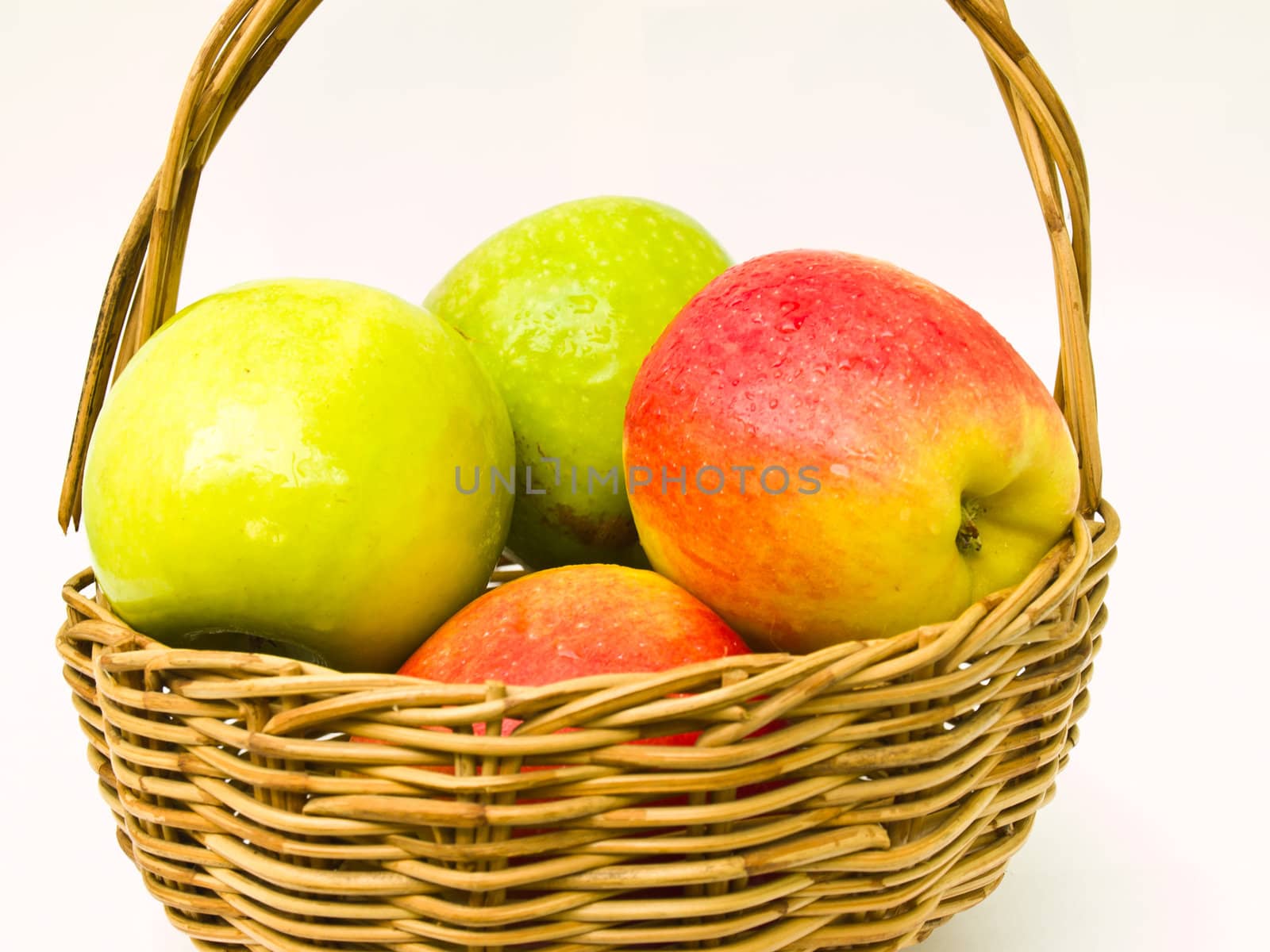 Green and red apples in a basket