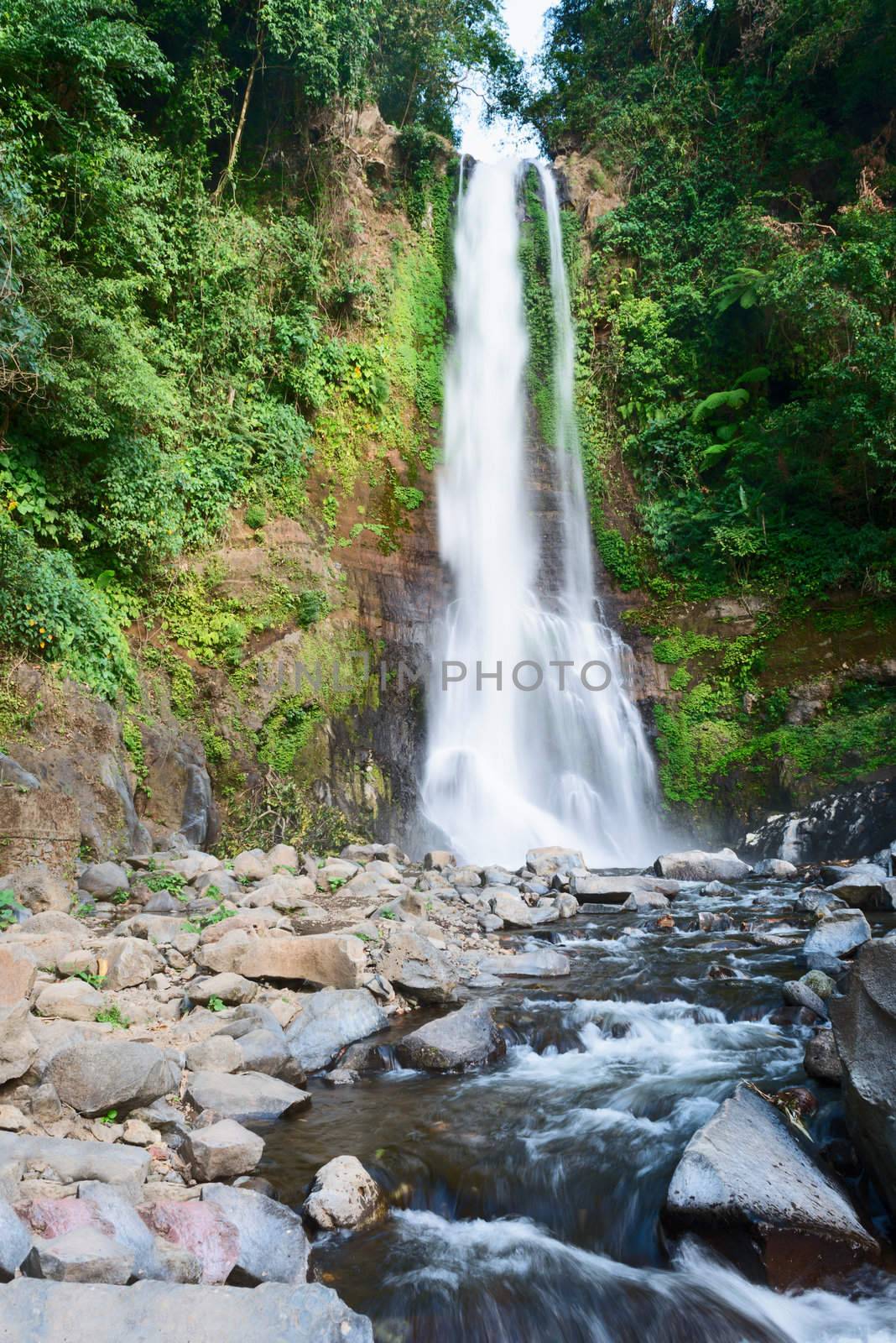 Sacred waterfall Gingit in green tropical forest 