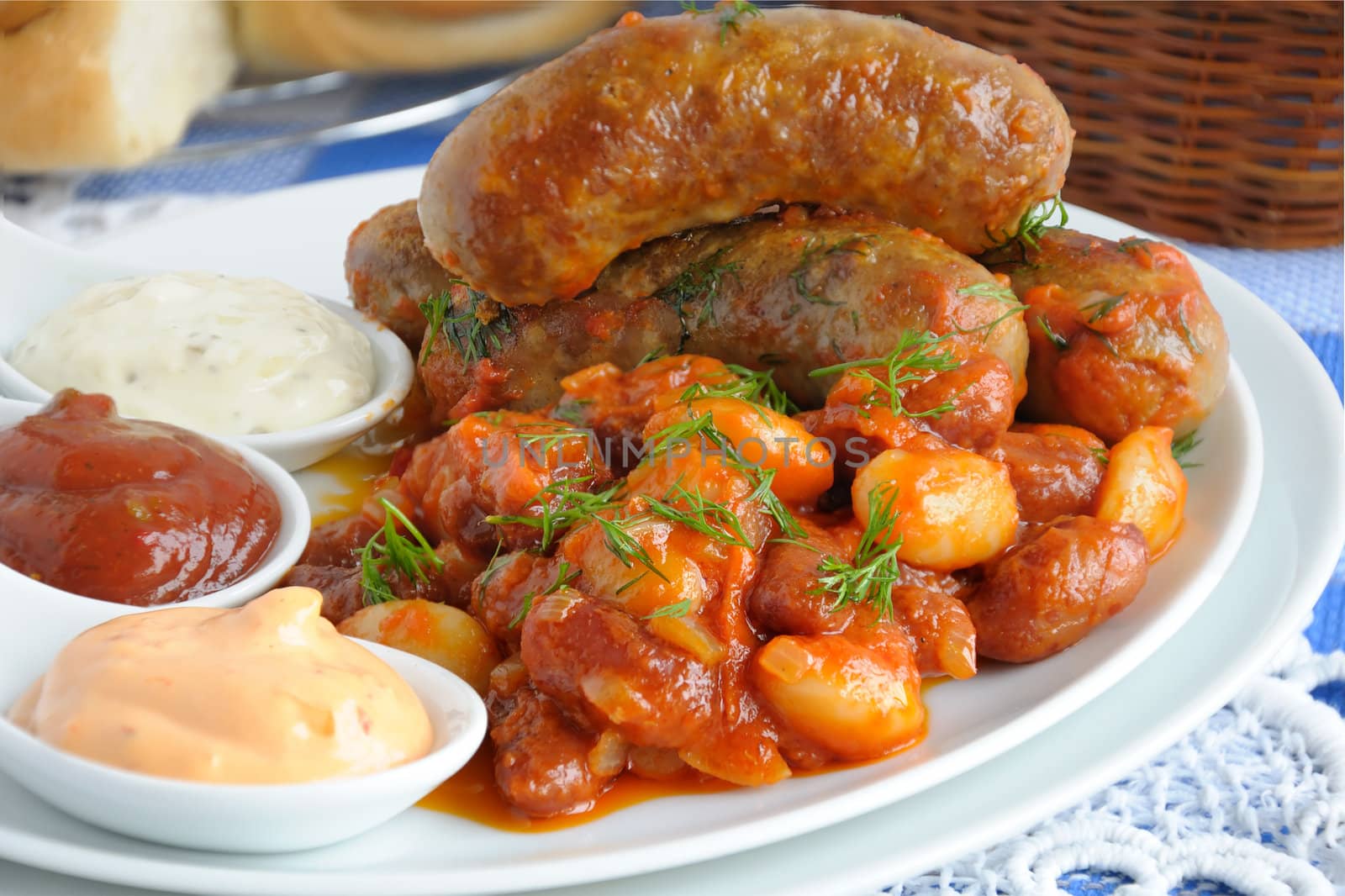 Home sausage with beans, onions and carrots in a tomato sauce