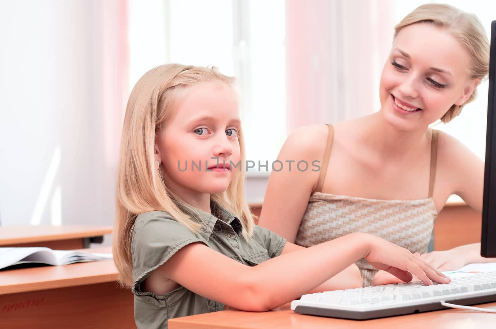 teacher explains the task schoolgirl at the computer, the new technologies in education