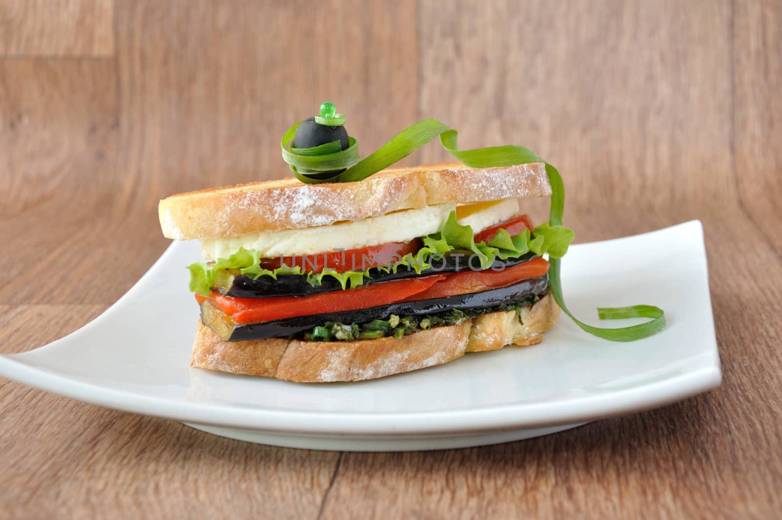  Sandwich with eggplant, tomatoes, peppers and cheese