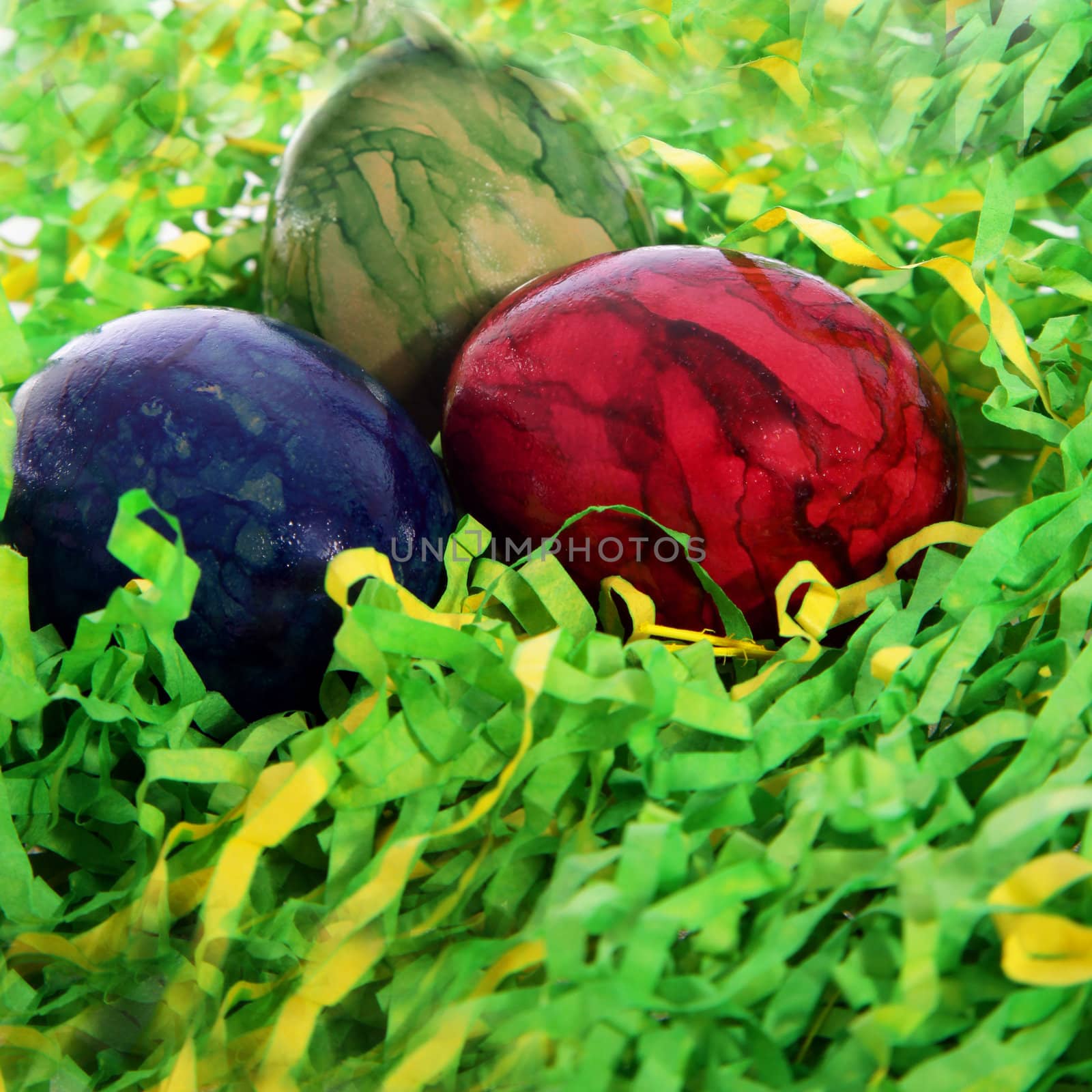 Red, blue and green colrored Easter eggs