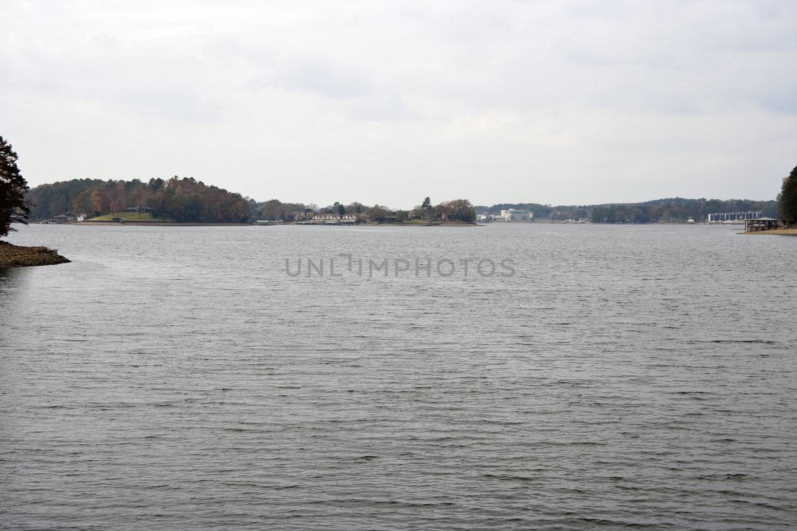 A scenic lake view with calm waters and cloudy sky