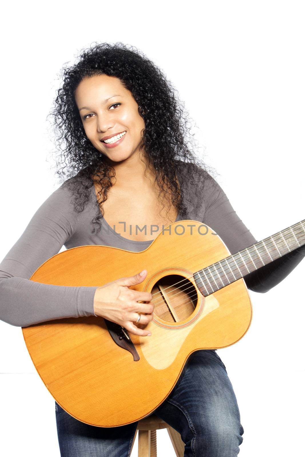 Portrait of beautiful black woman playing the guitar