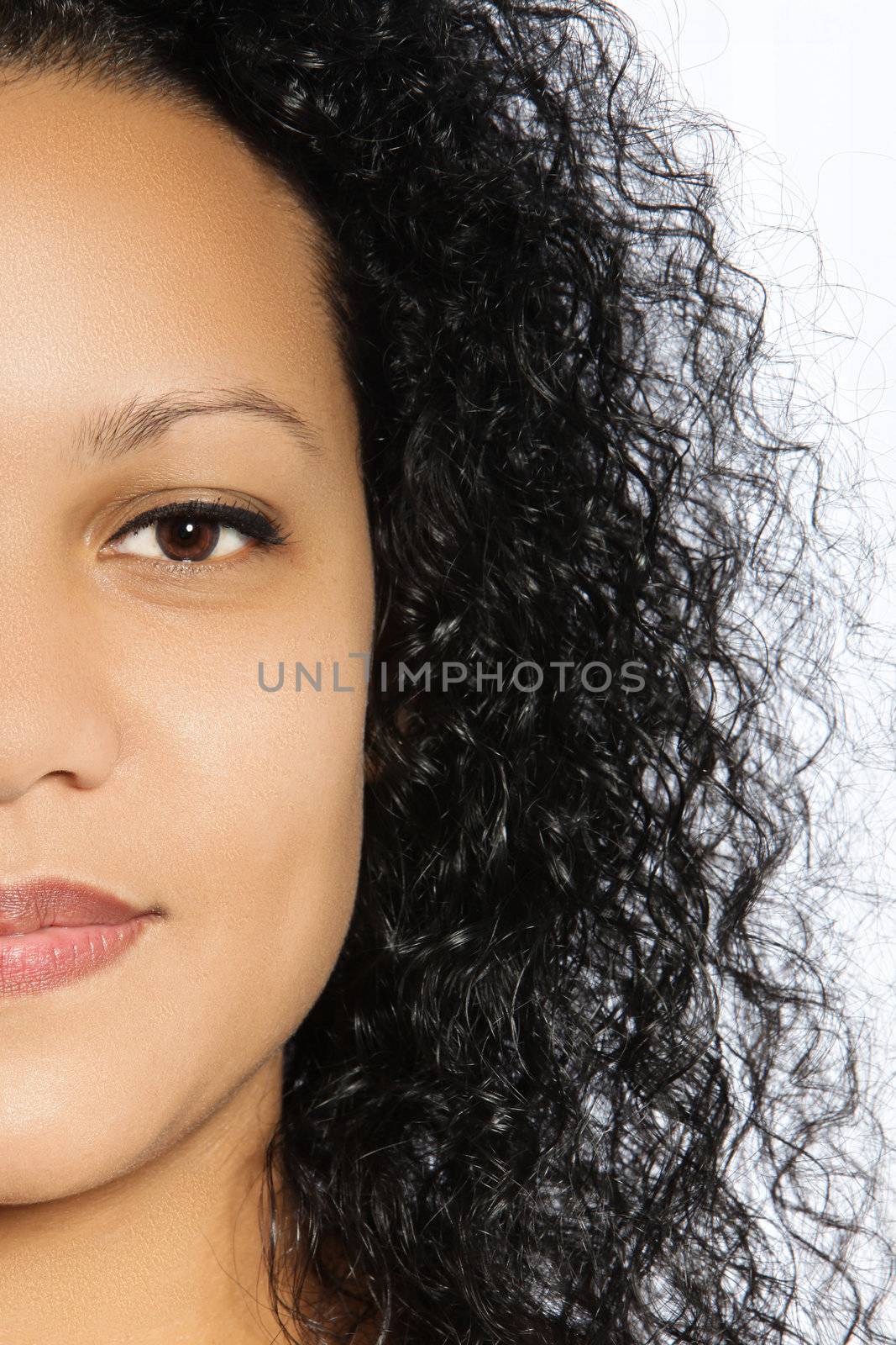Half faced portrait of a beautiful girl with balck curly hair