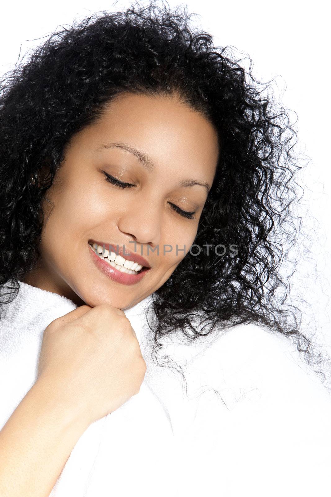 Beautiful girl with black curly hair, smiling with eyes closed