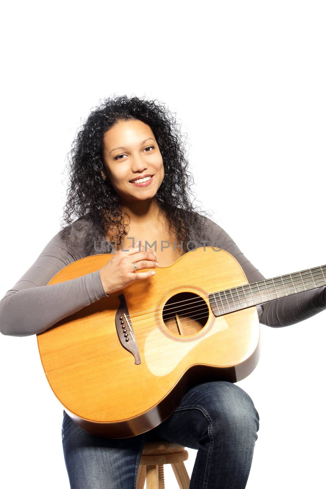 Smiling woman posing with guitar over the white background