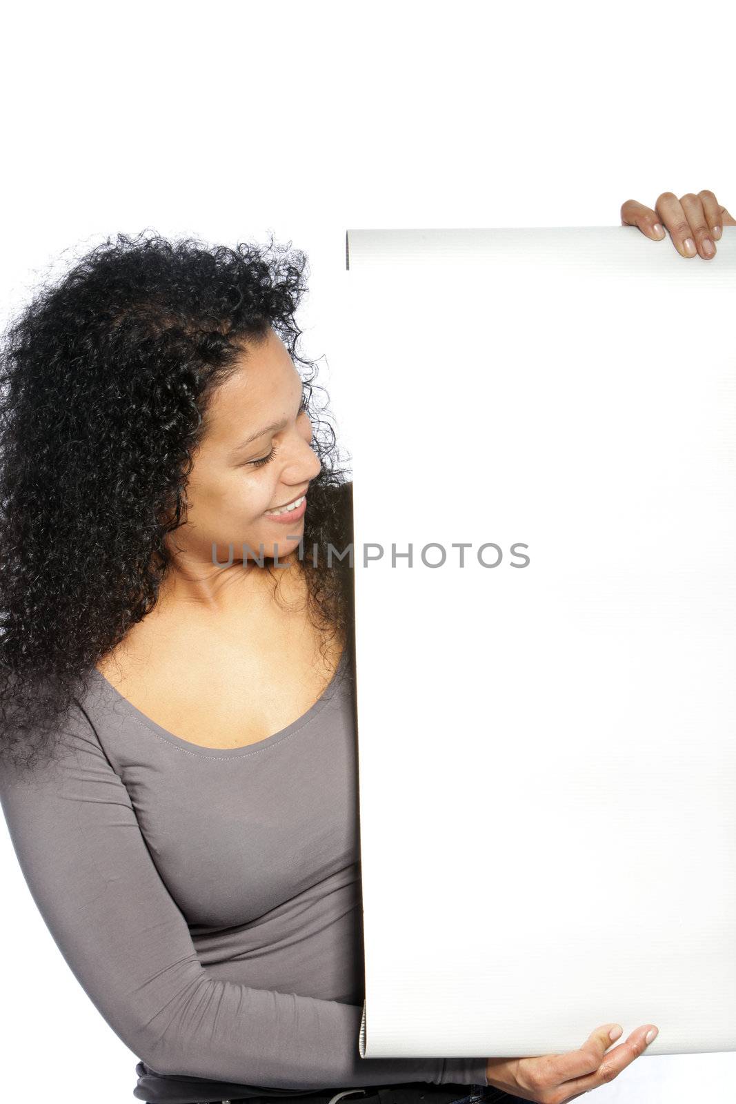 Smiling woman holding and looking on white blank banner isolated on