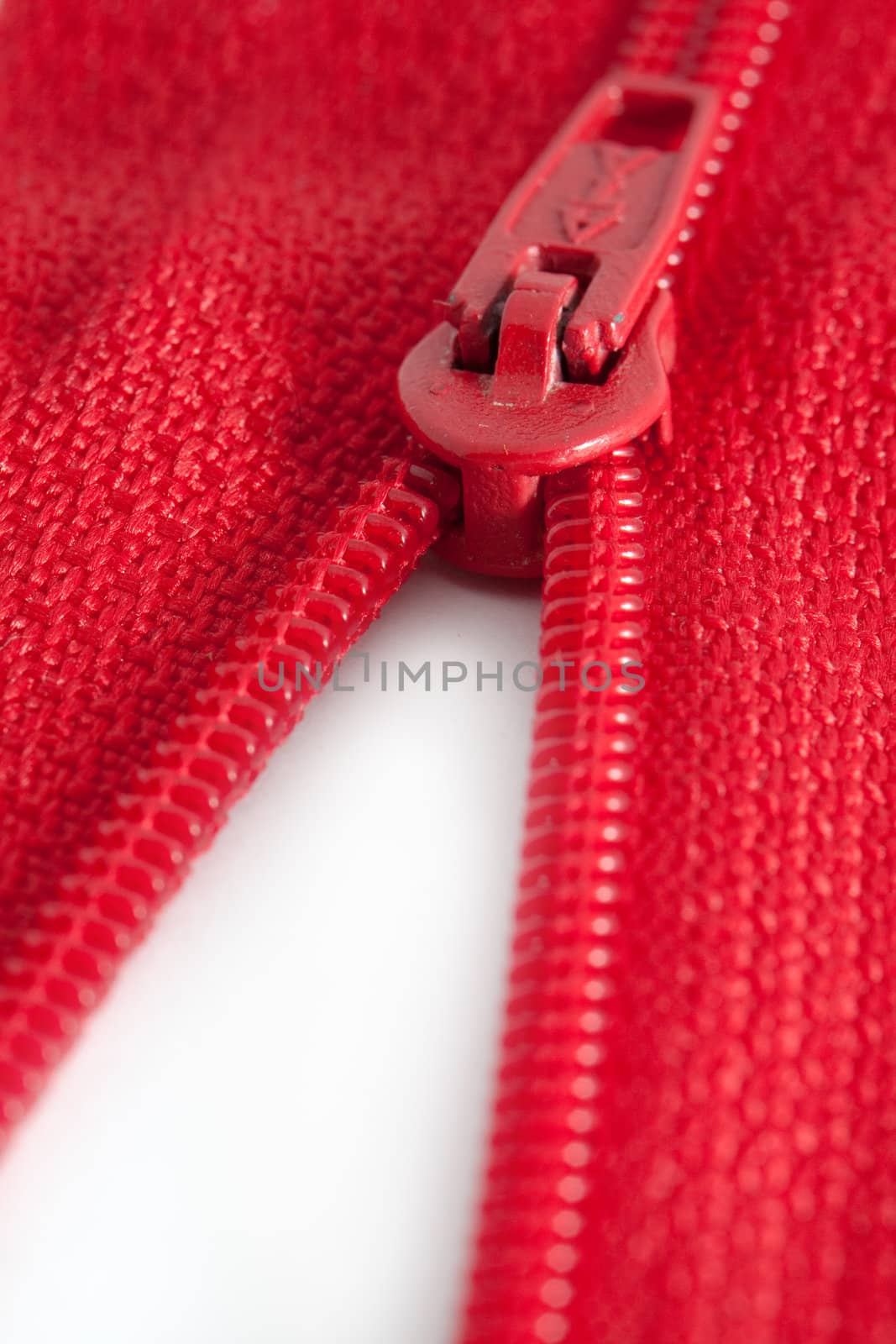 Open red zipper on a white background