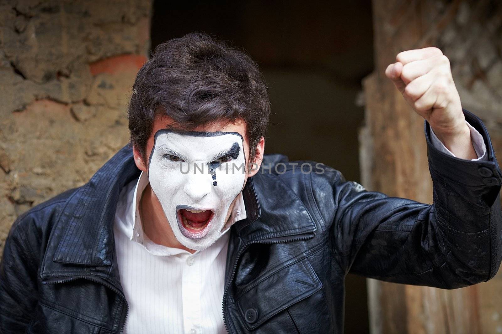 Portrait of a Man ​​mime. Threatens fist