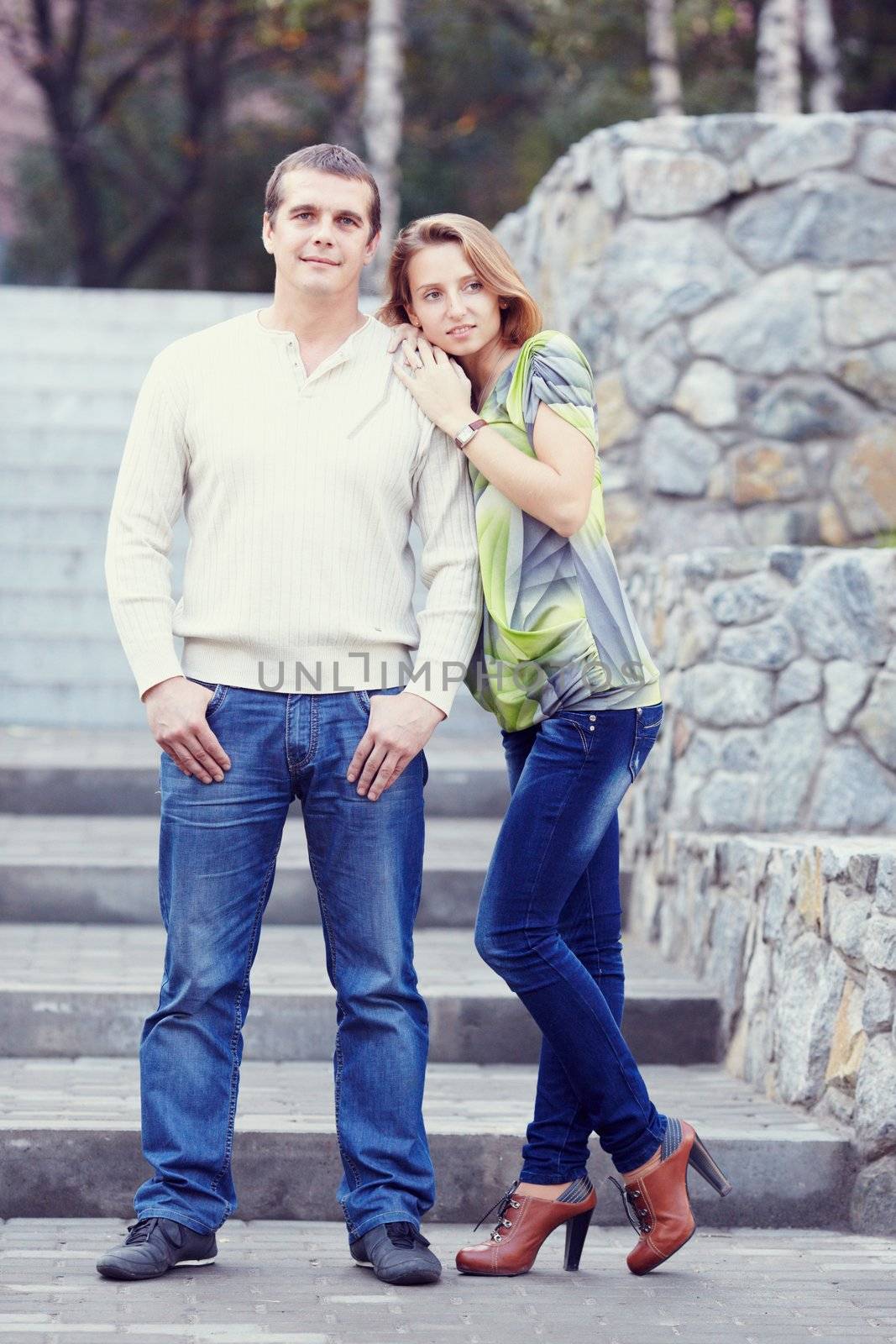 couple stand side by side and looking at the camera