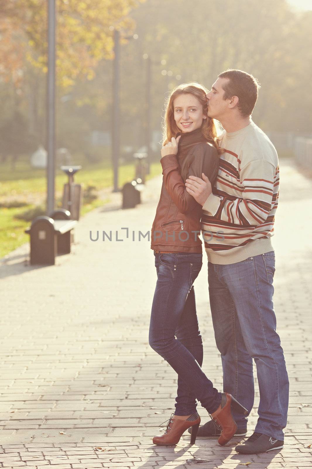 couple stand side by side and looking at the camera