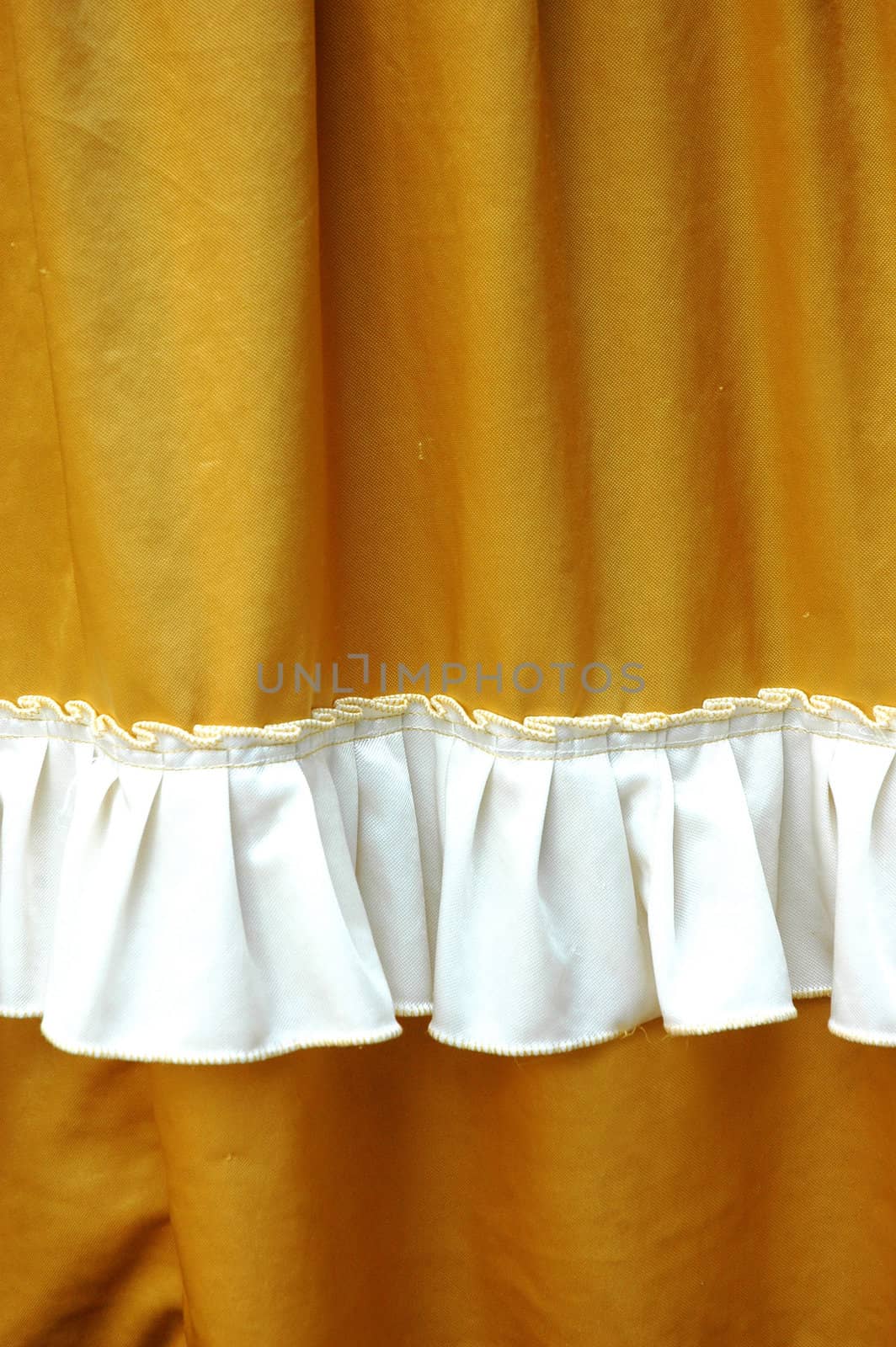 golden fabric decoration with white fringe