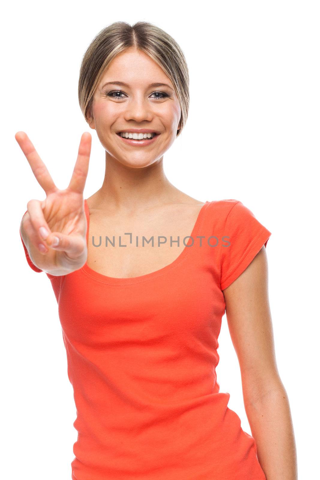 Young woman showing two fingers, positive or peace gesture, on white