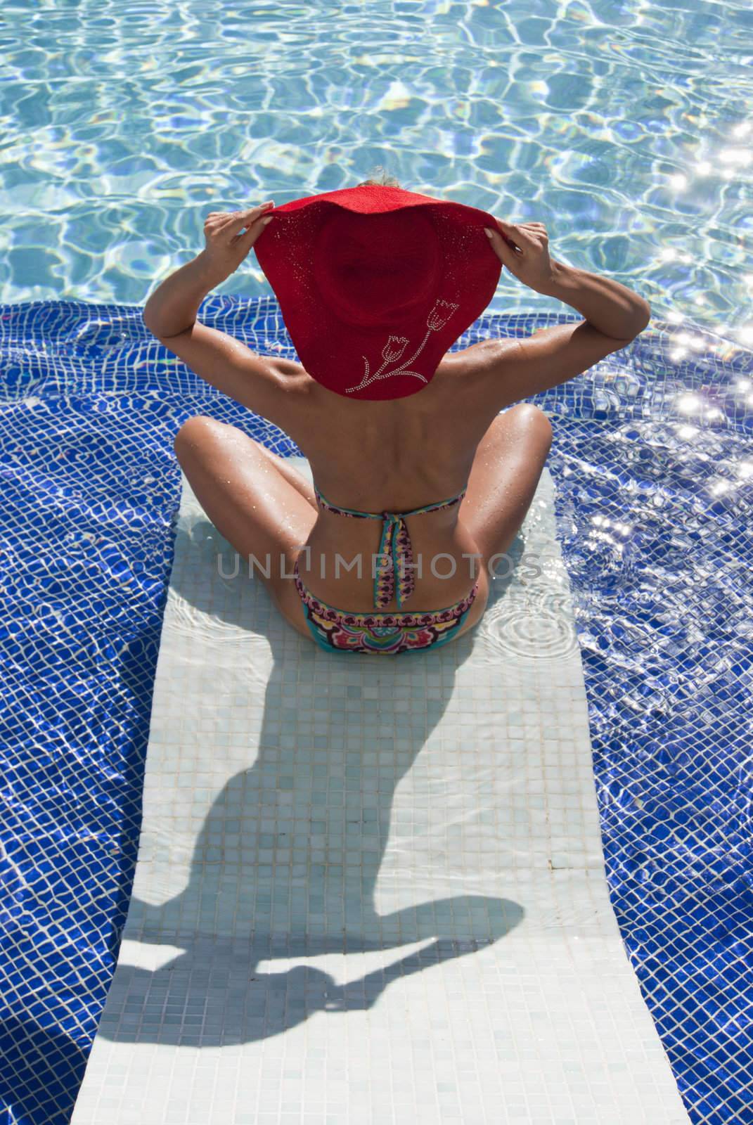 Beautiful woman in bikini relax in blue pool