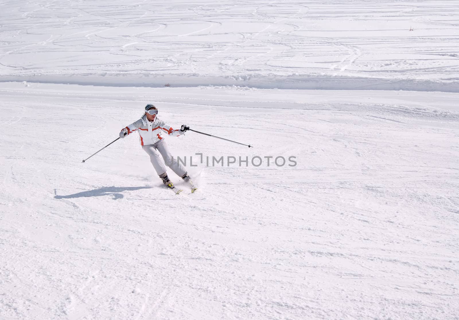 Beautiful skier on the downhill in sunny day