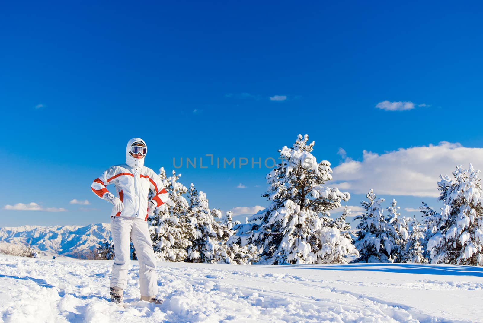 Serious beautiful skier on the top of mountain