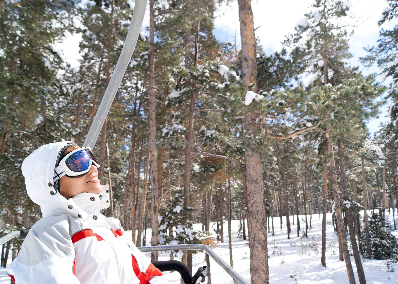 Beautiful skier going on chairlift in forest. Sarikamis. Turkey