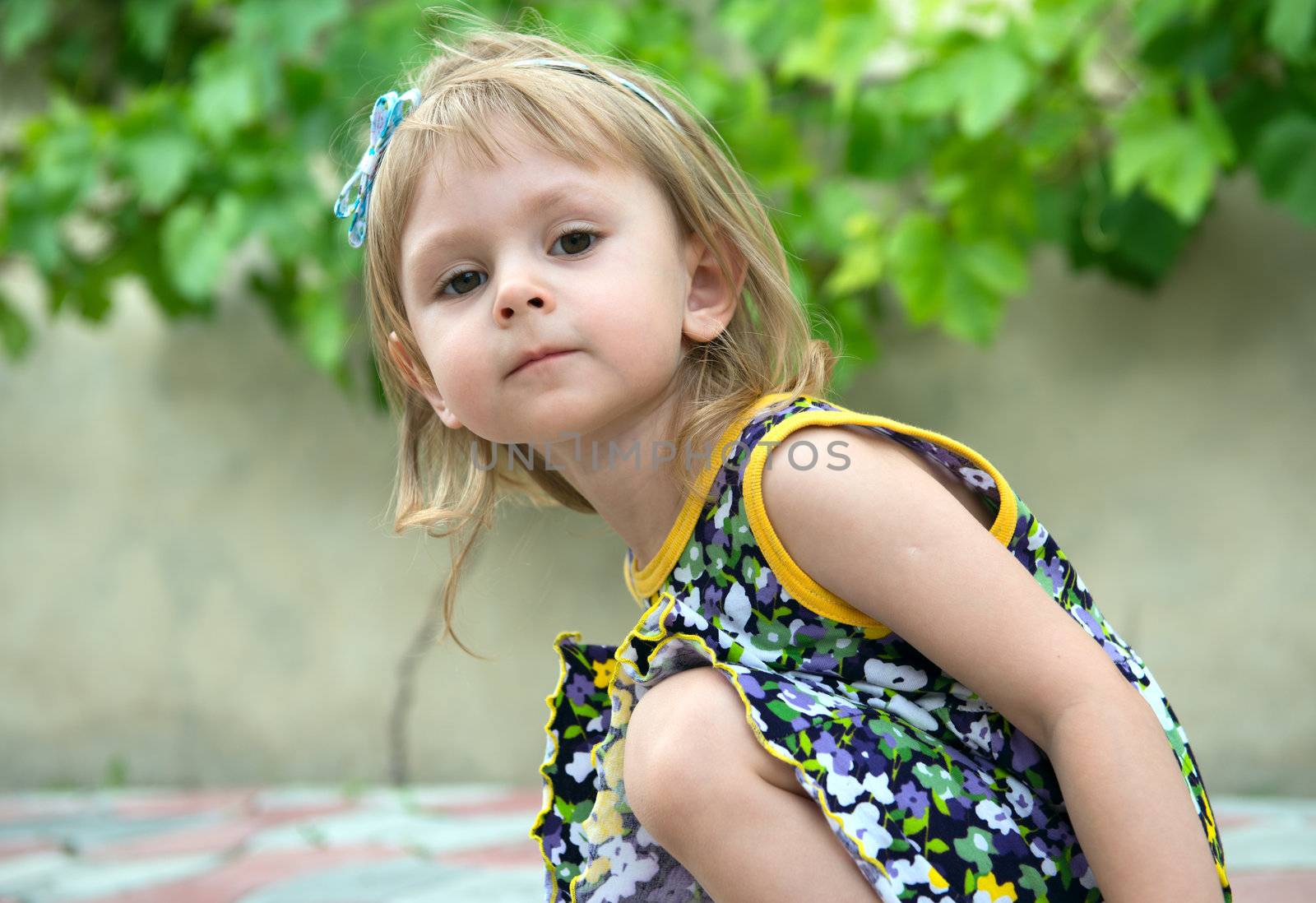 Little girl drawing images by chalk