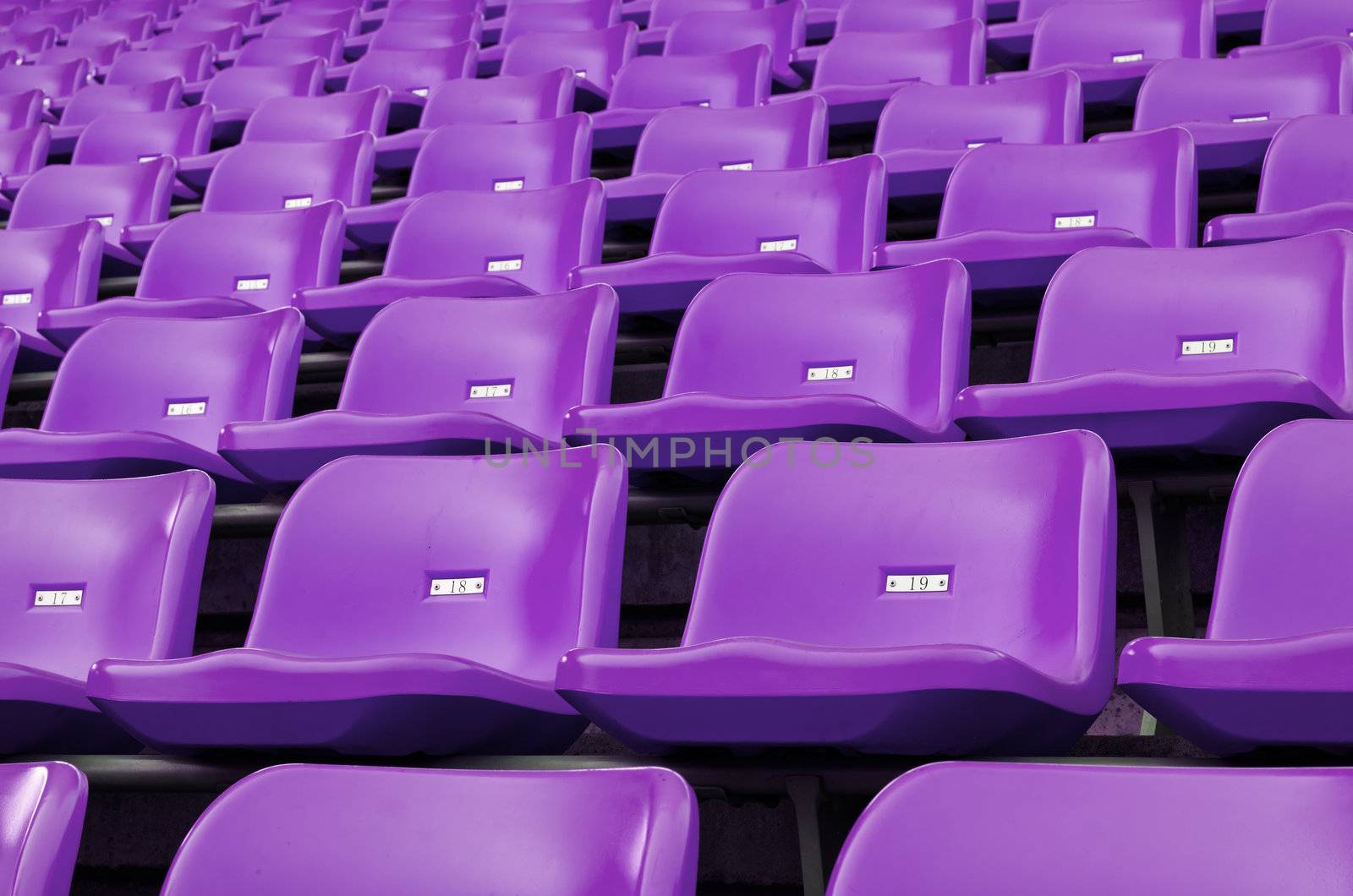 Purple Empty plastic seats at stadium open door sports arena