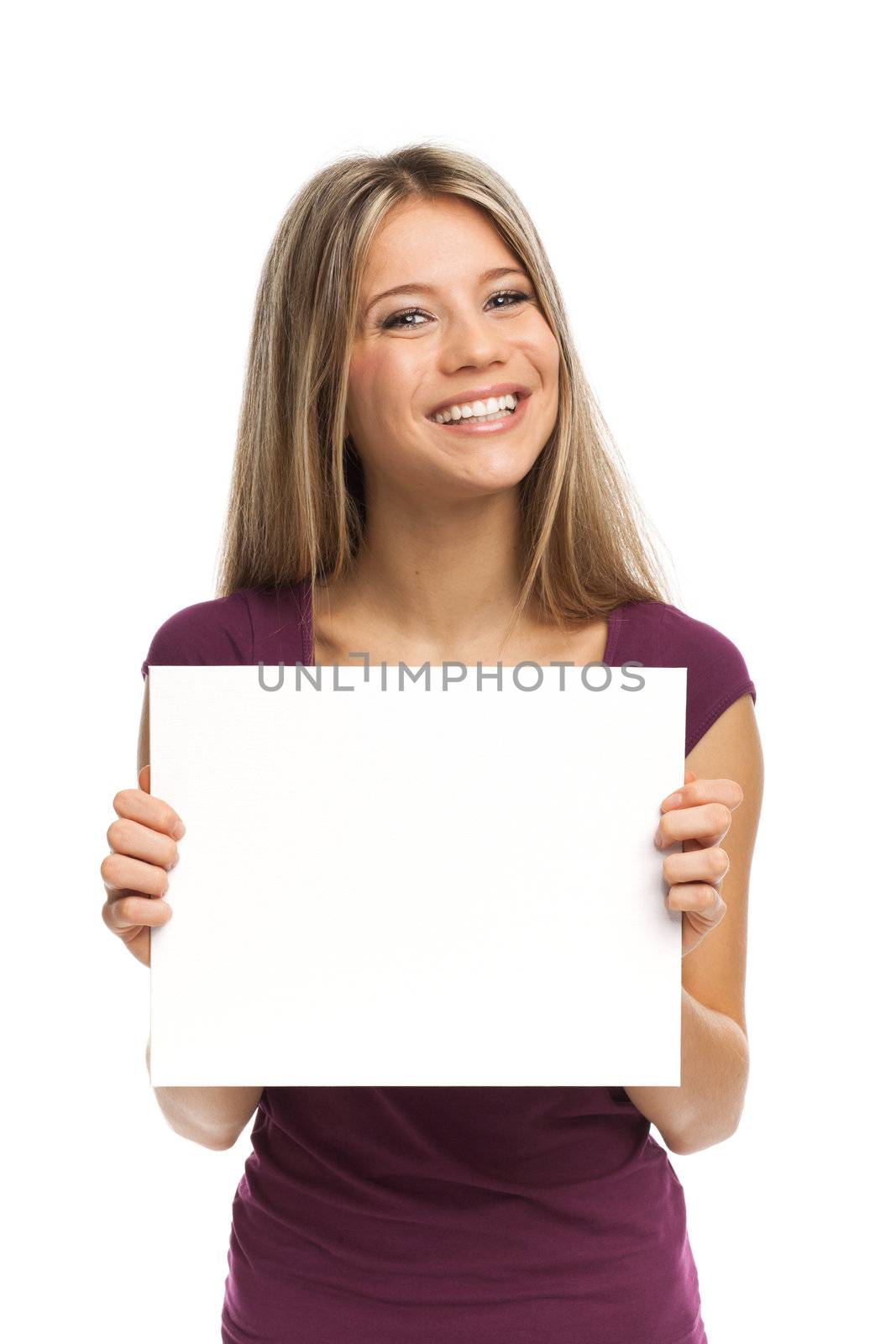 Beautiful blond woman smiling showing a white signboard, isolated on white