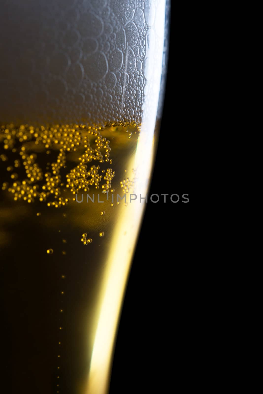 Fresh beer with froth and condensed water pearls on white  background