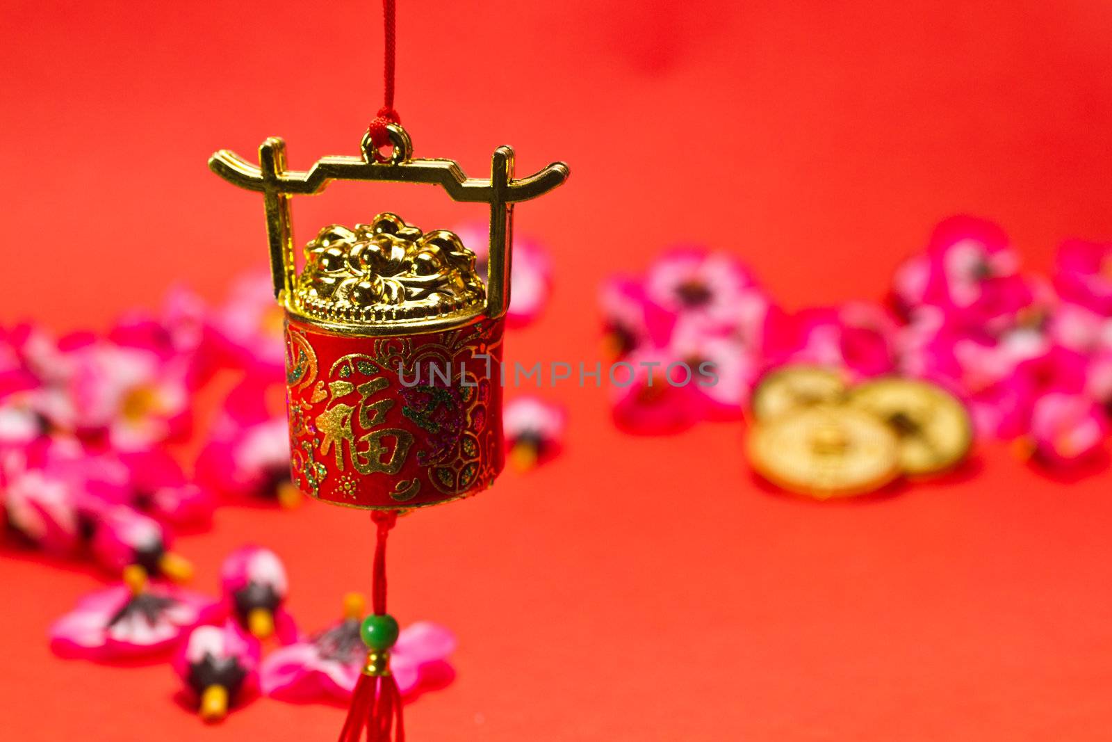 Chinese New Year ornament on red background with cherry blossom and gold coins for festive using