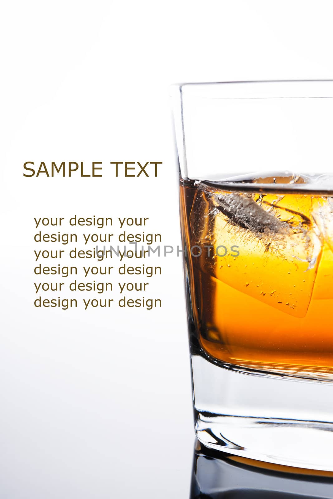 glass of whiskey with ice cubes on white background