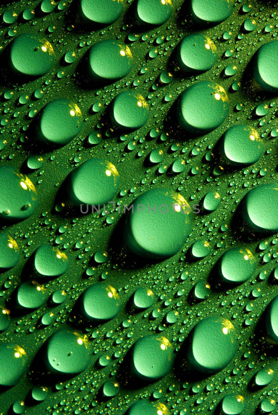 Crystal clear water drops over green background