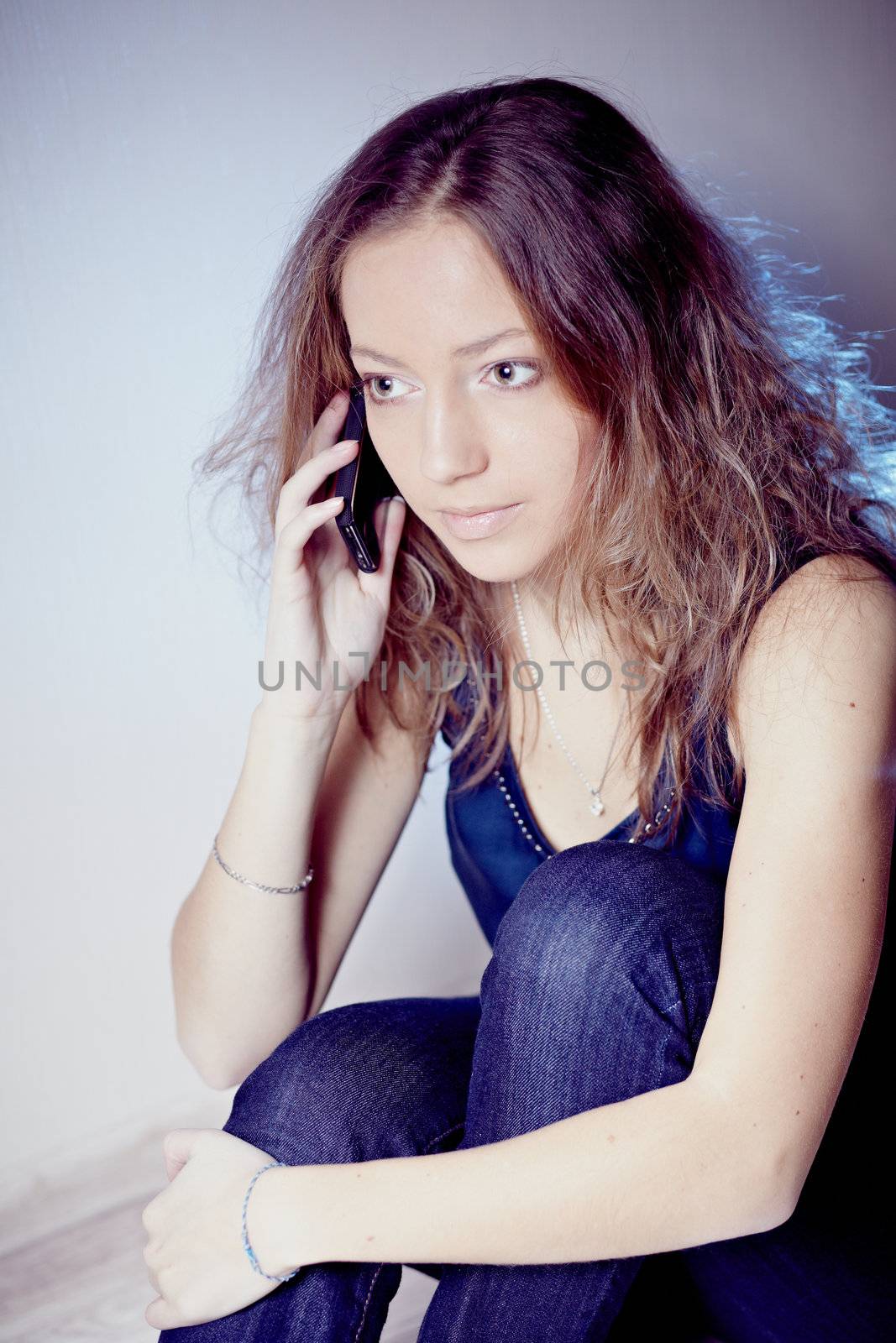 Beautiful girl talking on the phone. Sensual and sexy look