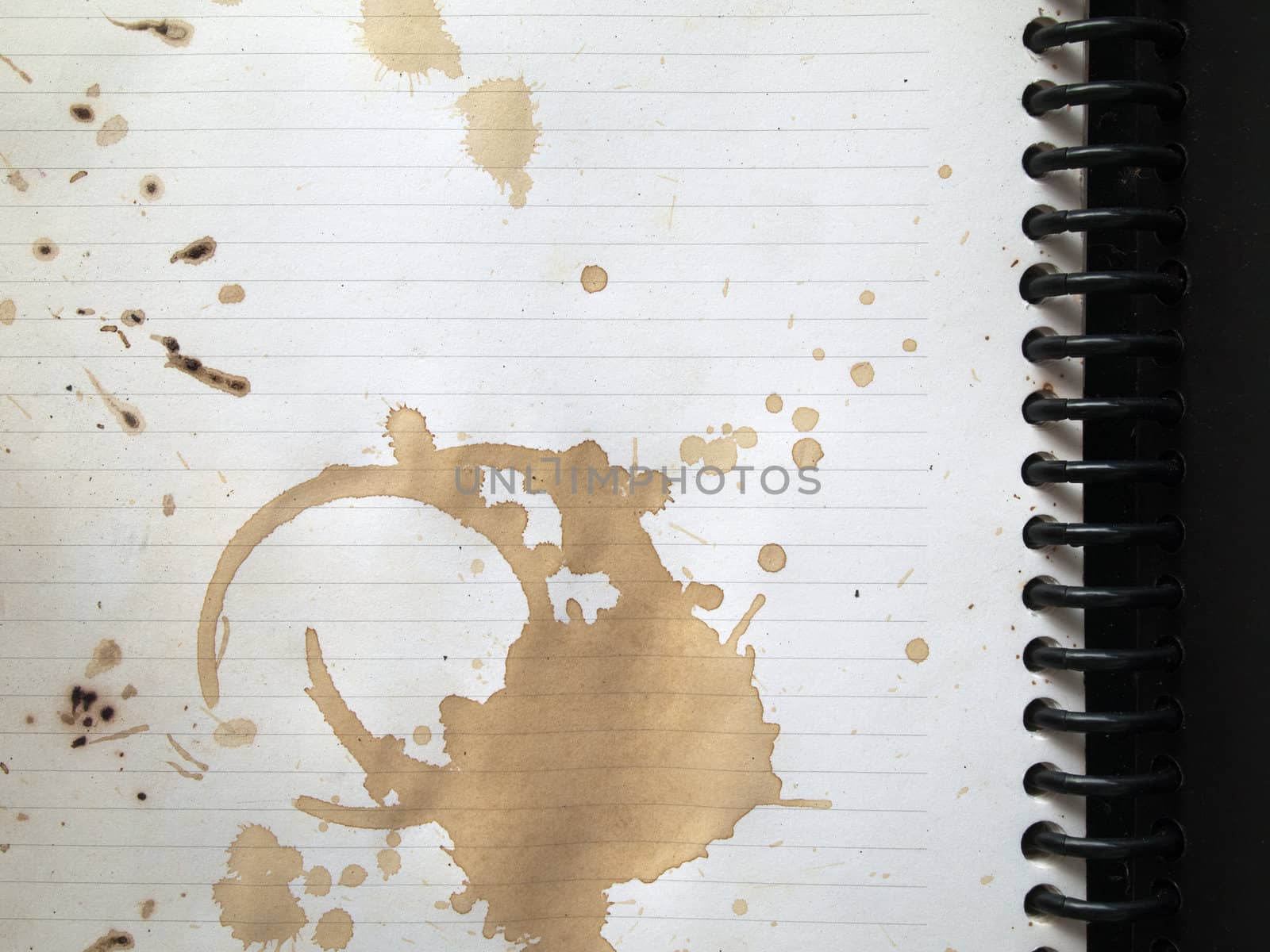 Coffee stains on note book by nuttakit