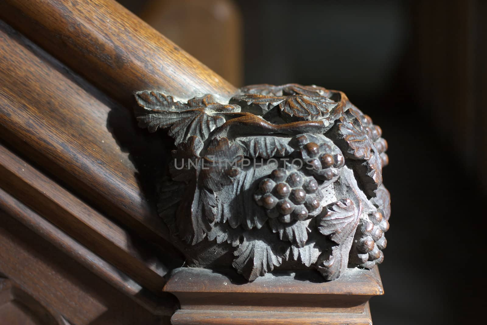 Detail (grapes) of wooden staircase to pulpit in Chetwode parish church, UK