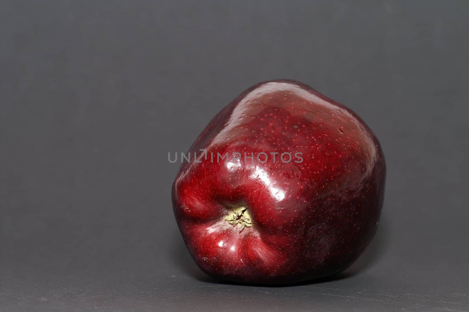 Big red apple on black paper