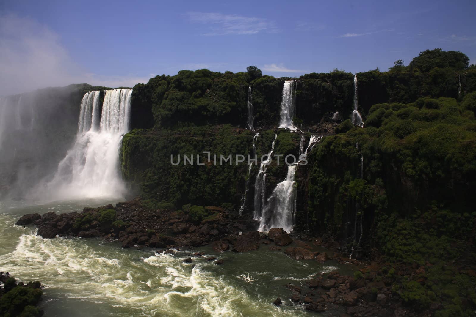 The Iguassu (or Iguazu) Falls is one of the largest masses of fresh water on the planet and divides, in South America, Brazil, Paraguay and Argentina. The waterfall system consists of 275 falls along 2.7 kilometres (1.67 miles) of the Iguazu River. Some of the individual falls are up to 82 metres (269 feet) in height, though the majority are about 64 metres (210 feet).