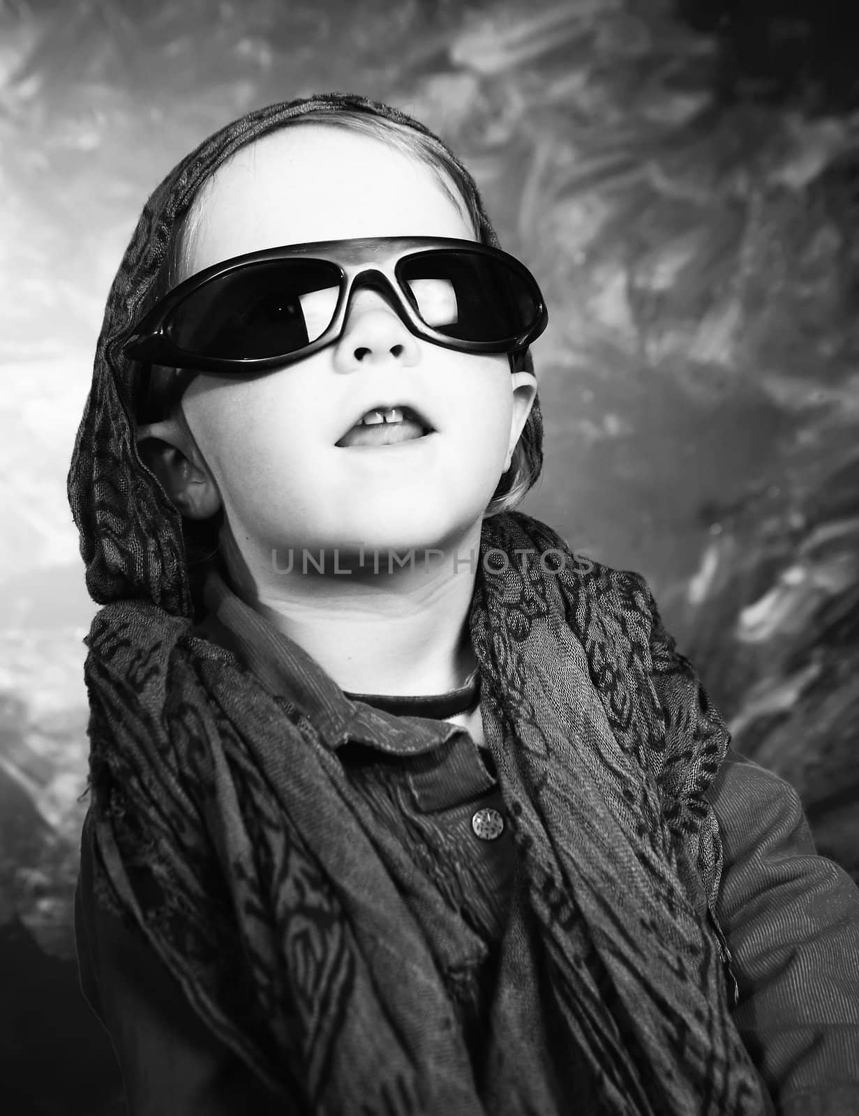 Little girl with sunglasses in a studio