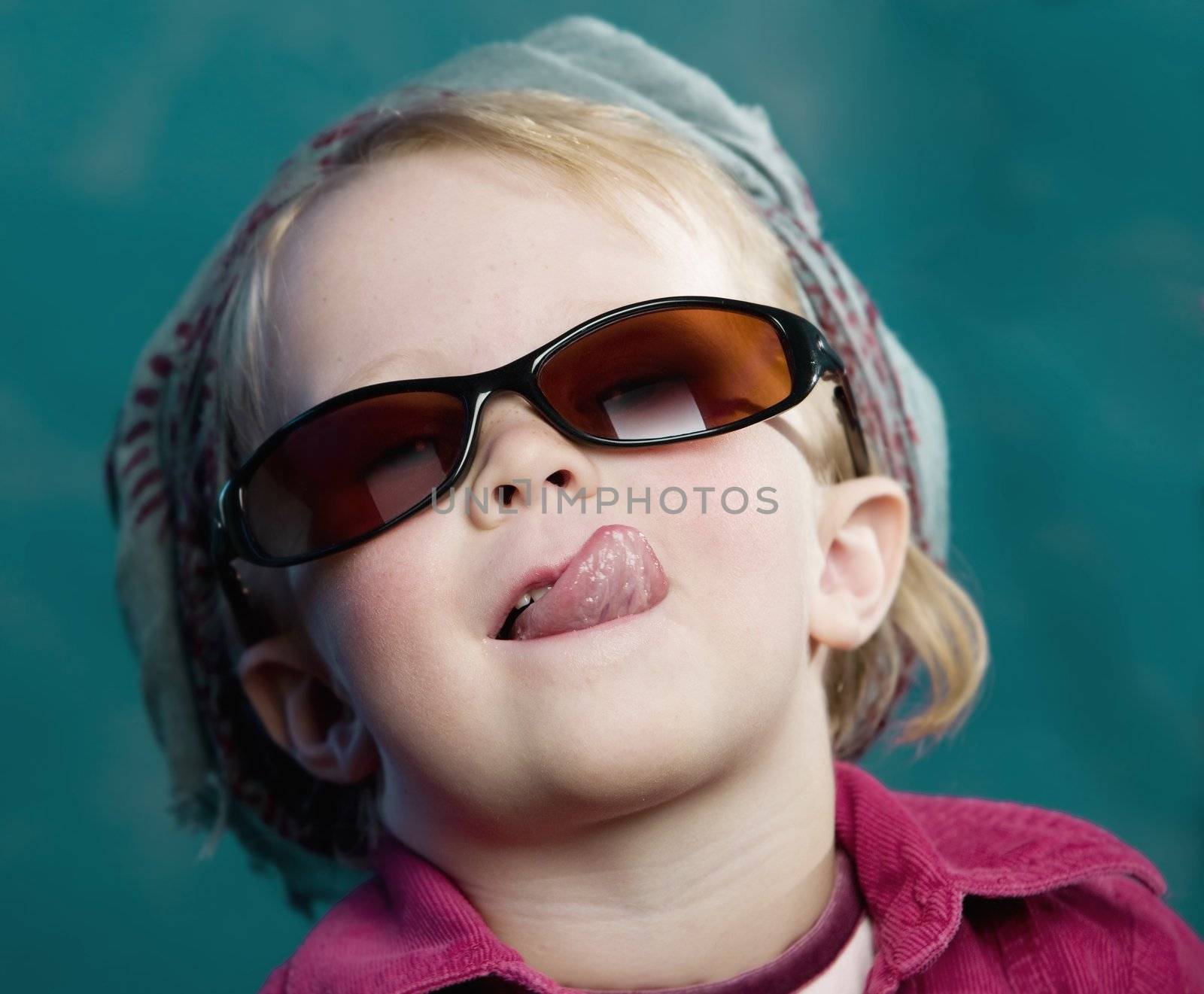 Little girl sticking out her tongue by Creatista