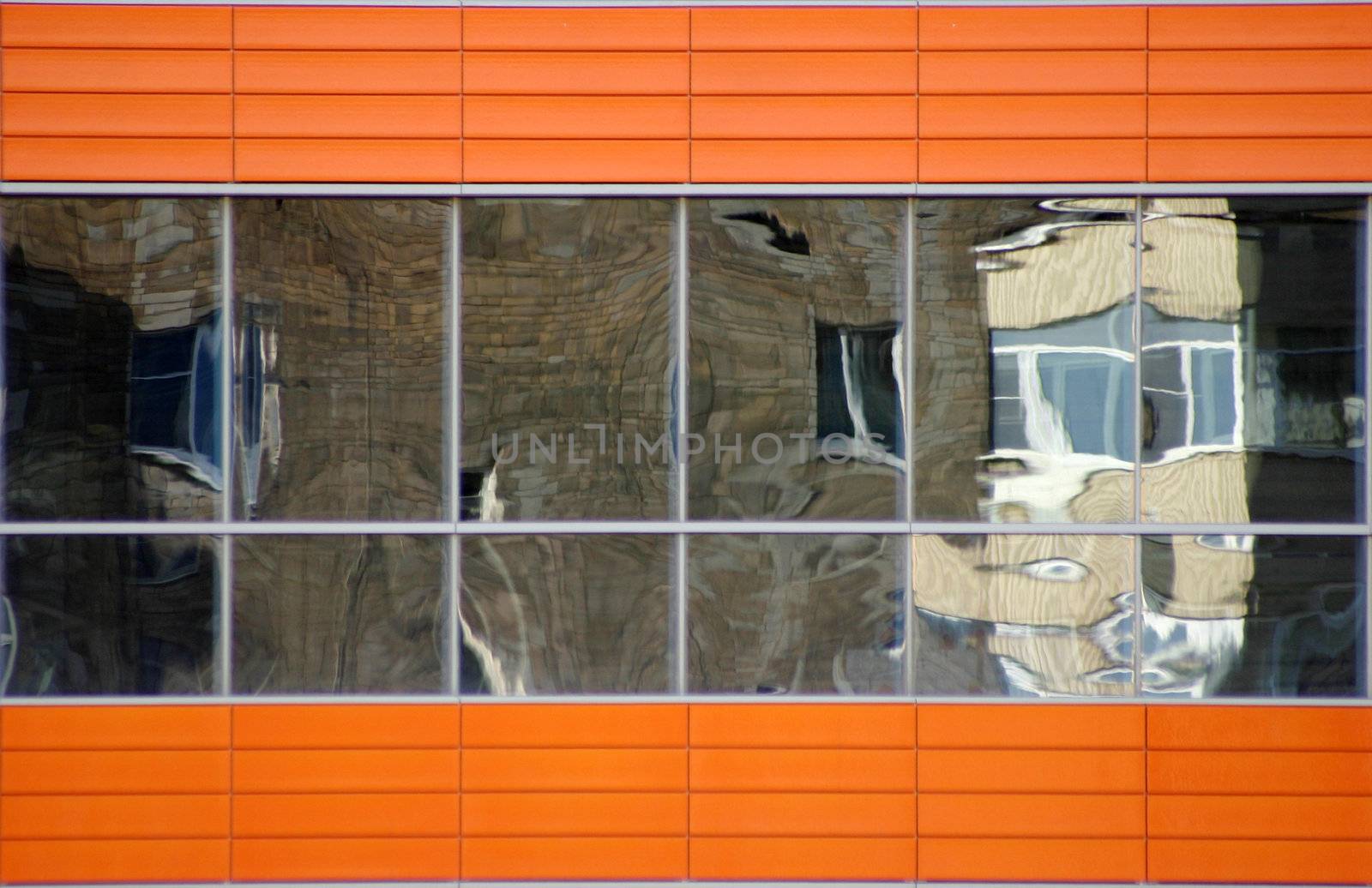 Distorted reflections of a brick wall in windows