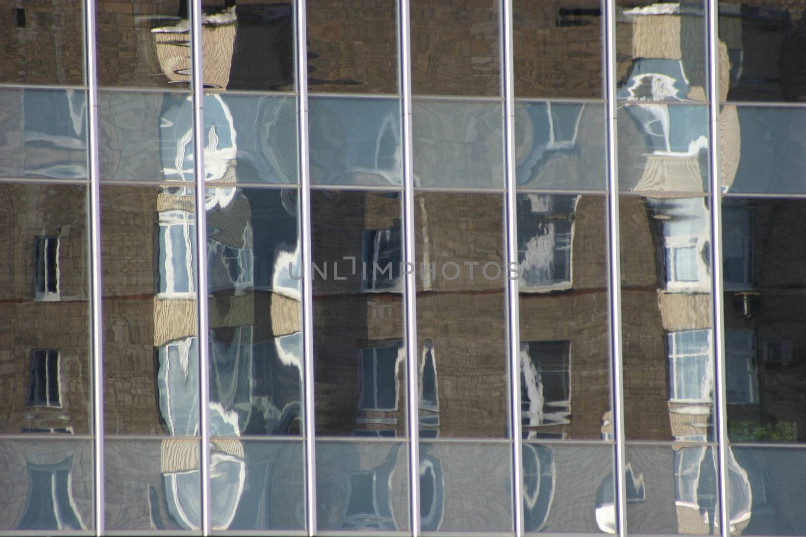 Distorted reflections of a brick wall in windows