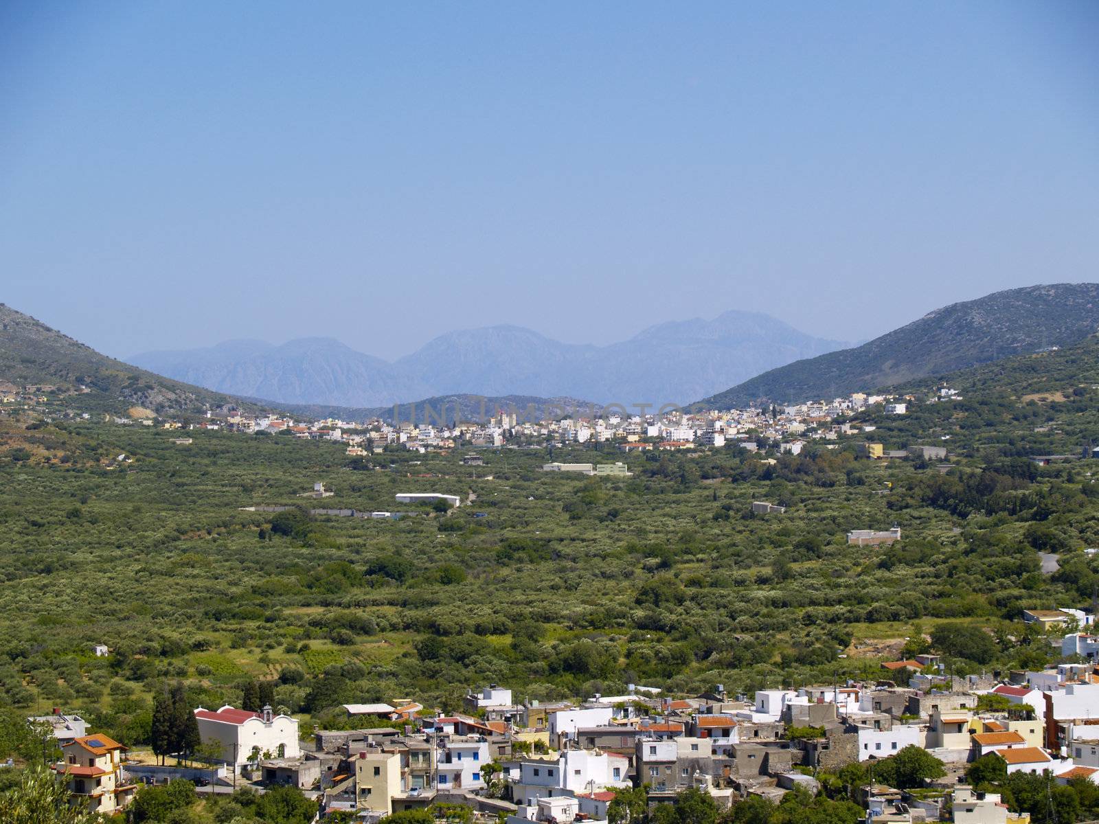 valley in rural cretan region, city of neapoli in the background