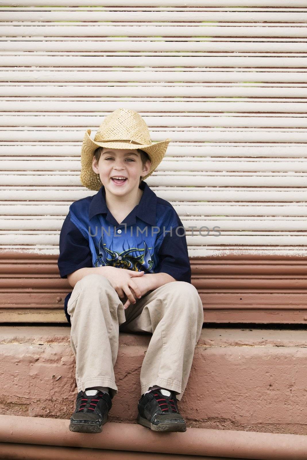Young Boy in a Straw Cowboy Hat Smiling Broadly
