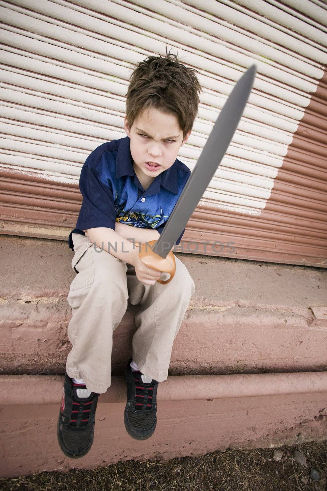Angry Young Boy Pointing a Plastic Sword