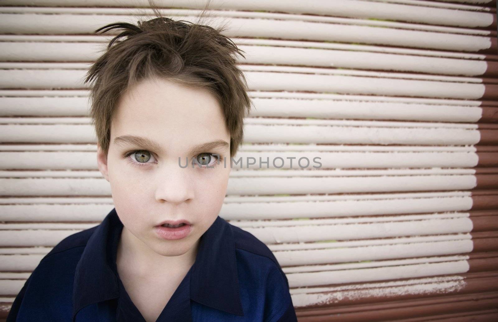 Young Boy with a Blank Stare and Green Eyes