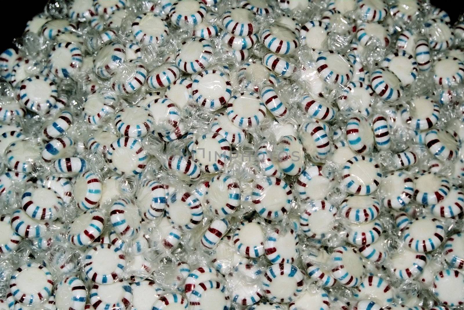 A large pile of peppermint candies