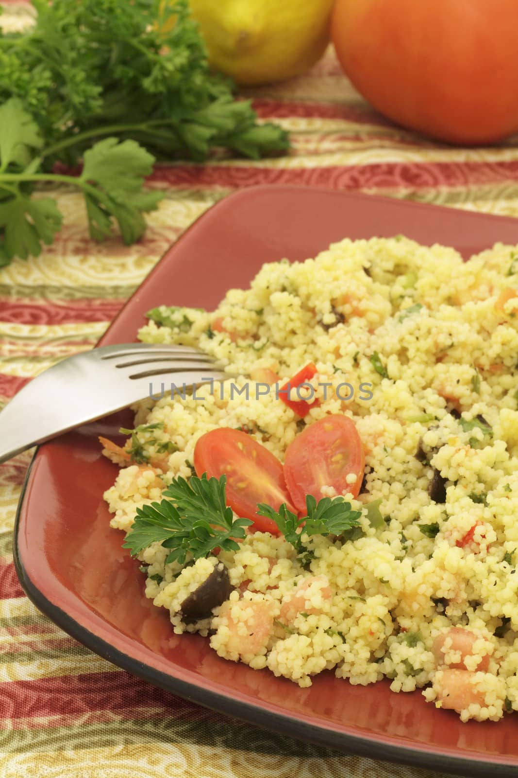 Mediterranean couscous salad on a colorful tablecloth