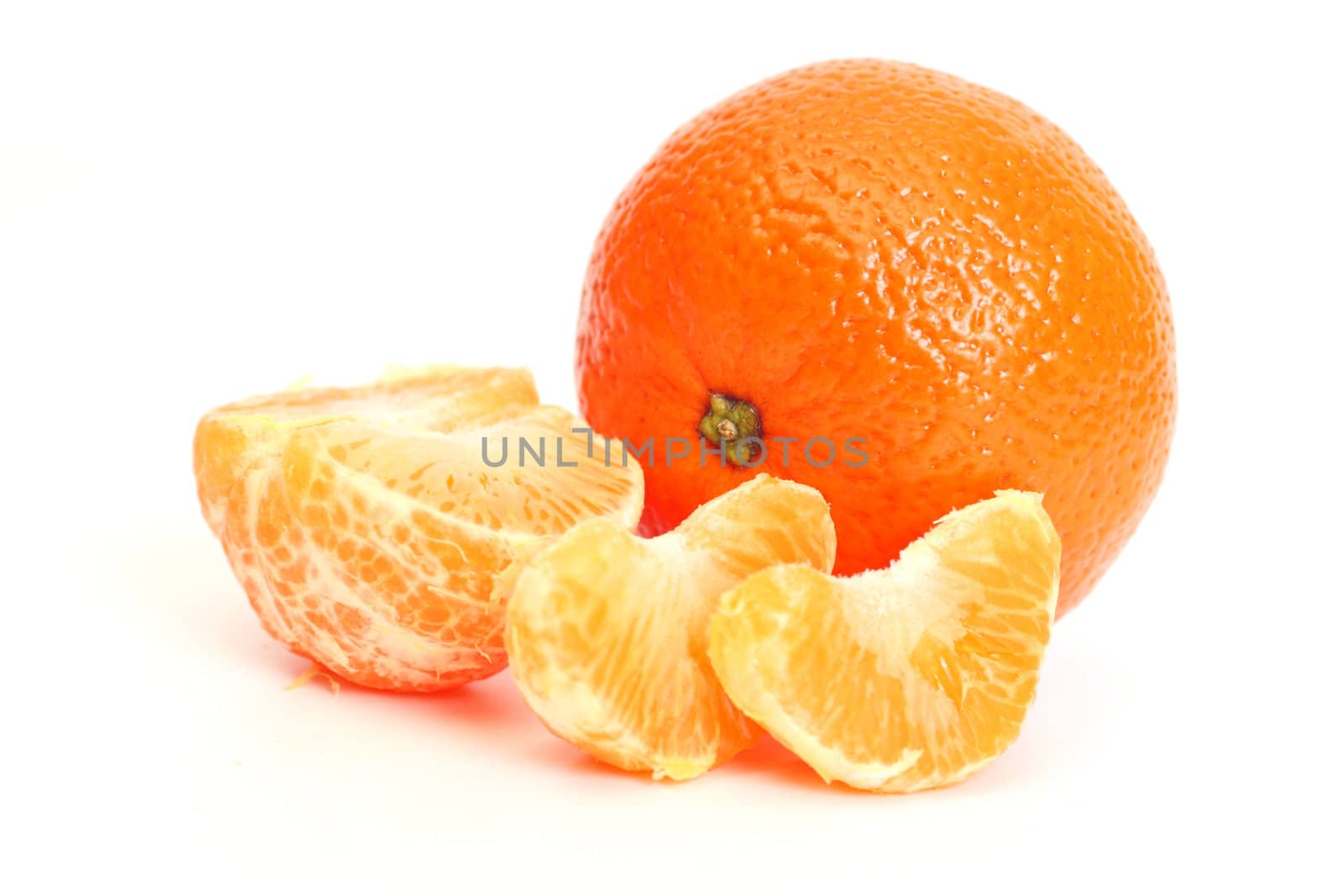 whole tangerine and segments of a tangerine