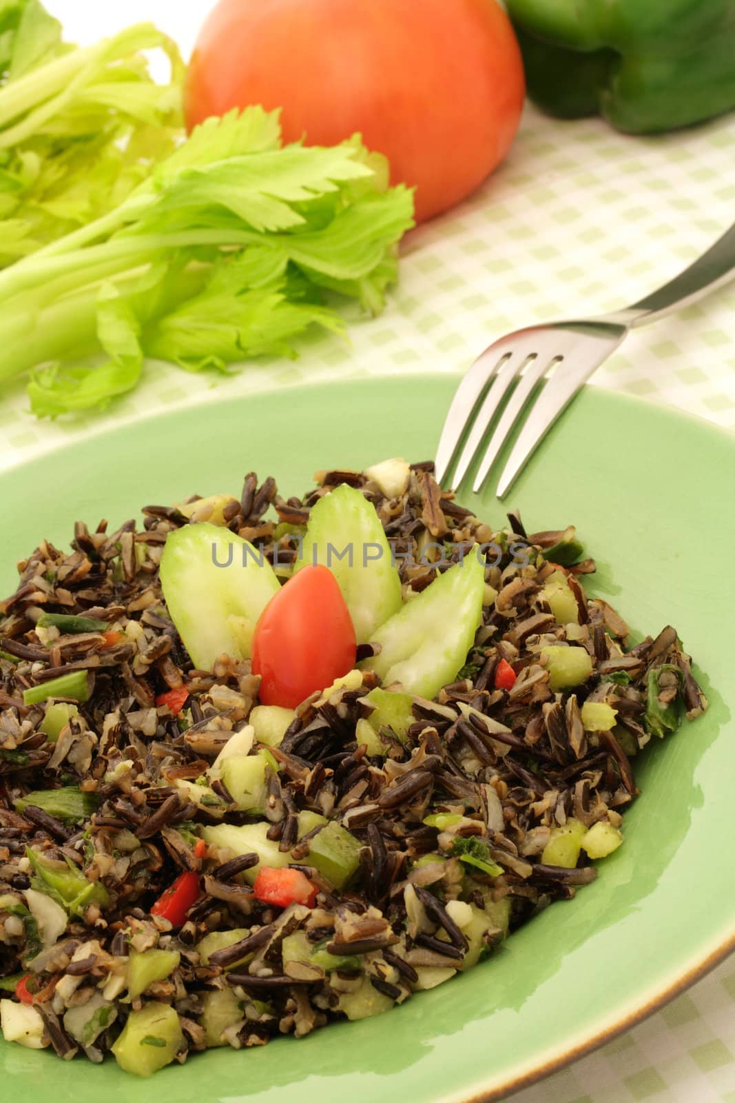 Healthy wild rice salad served on a green plate