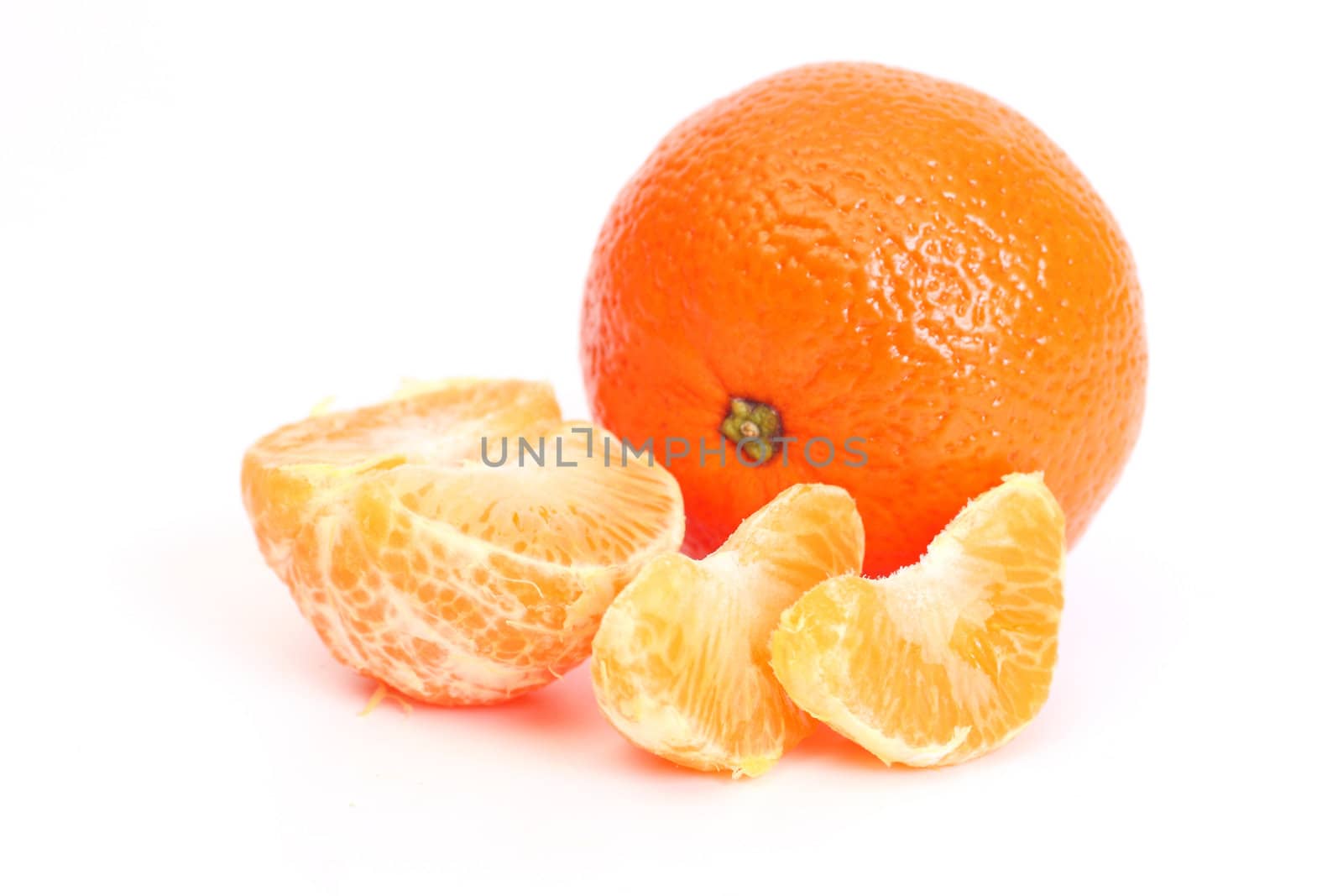 whole tangerine and segments of a tangerine